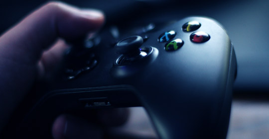 close up of hand holding a game controller